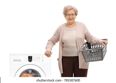 Elderly Woman With An Empty Laundry Basket Next To A Washing Machine Isolated On White Background