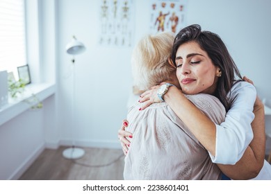 The elderly woman enjoys an embrace from her favorite home healthcare nurse. Medical care, young female doctor hugging patient. Empathy concept. Elderly woman hugging caregiver - Shutterstock ID 2238601401