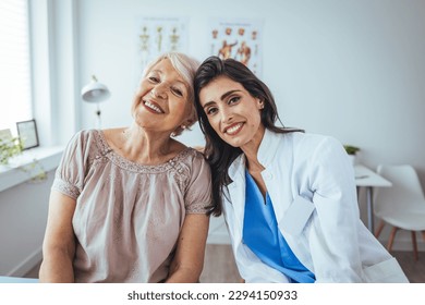 The elderly woman enjoys an embrace from her favorite home healthcare nurse. Medical care, young female doctor hugging patient. Empathy concept. Elderly woman hugging caregiver - Powered by Shutterstock