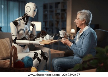 An elderly woman enjoys her afternoon tea, served by her robotic servant.
