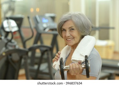 Elderly Woman Exercising In Gym