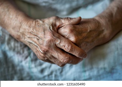 Elderly woman with folded hands. Hands of an old woman close up.
