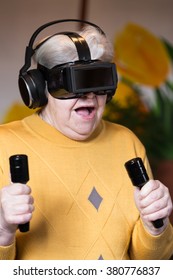 elderly woman with gaming simulator and controller is looking surprised