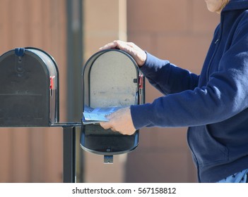 An Elderly Woman Getting Her Mail From Mailbox.