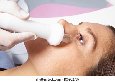 Elderly Woman Getting High Frequency Skin Treatment In Spa