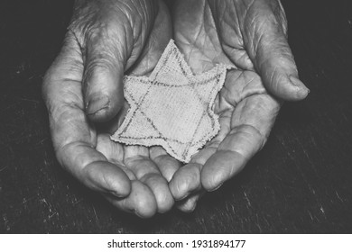 elderly woman hand and star of David on a wooden board background. Remembrance Day