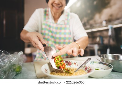 Elderly Woman Hand Using Knife Cooking With Love For Family Dinner Food Concept. Local Traditional Thai Style Indoors Kitchen At Home.