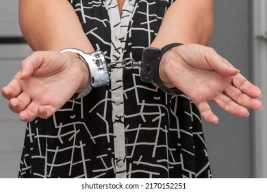 An Elderly Woman In Handcuffs On A Blurry Background In An Apartment. An Elderly Criminal, Criminal Liability Of Pensioners, Domestic Violence Against Women.