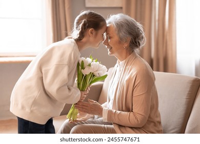 An elderly woman is handing a colorful bouquet of flowers to a young girl, who looks delighted and thankful. The scene captures a heartwarming moment of intergenerational kindness. - Powered by Shutterstock