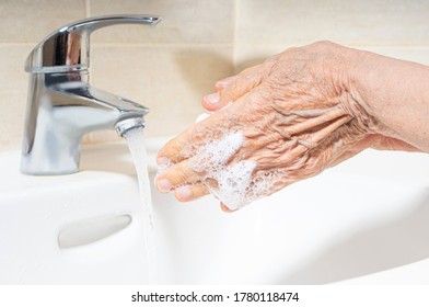 Elderly woman hands washing. Hand hygiene to prevent infection. Take care of the elderly.  - Powered by Shutterstock