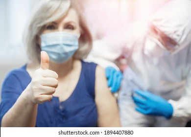 Elderly Woman Happy, Showing Thumbs Up - Signal Good On Getting Vaccine From Covid-19. Nurse Vaccinates Coronavirus Senior People.