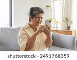 Elderly woman have eyesight problem can not read because seeing text blurred and headache from eye tired.