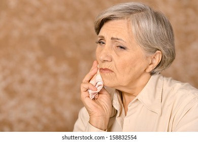 Elderly Woman Having Bad Tooth Pain Isolated On Brown