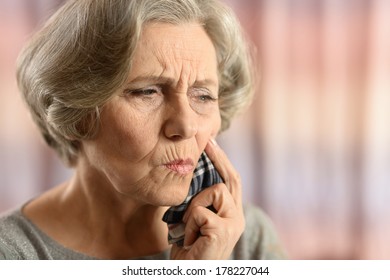 Elderly Woman Having Bad Tooth Pain Isolated On Colored Background