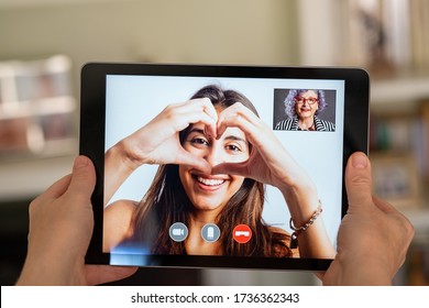 Elderly Woman Having Video Call With Her 
Granddaughter On Tablet