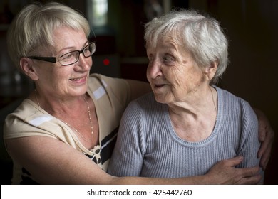 An Elderly Woman With Her Adult Daughter.