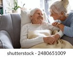 Elderly woman with her caregiver at nursing home
