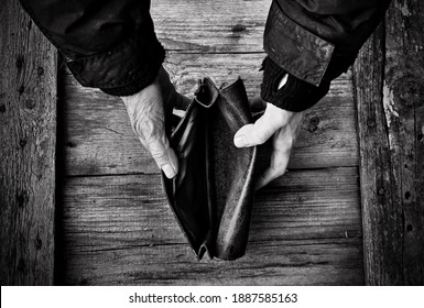 An Elderly Woman Holds An Empty Purse Or Wallet On Wooden Vintage Table. Black And White Photo.The Concept Of Poverty In Retirement. Global Extreme Poverty. No Money Help Me. Global Financial Crisis.