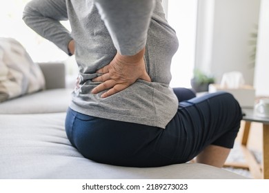 Elderly Woman At Home With Lower Back Pain