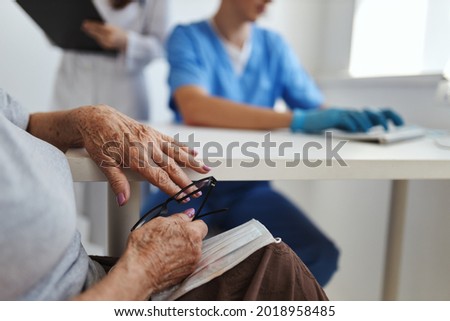 Similar – Female doctor filling out a questionnaire to senior patient