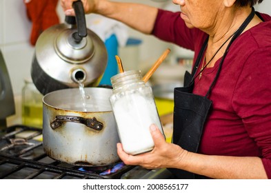 Elderly woman in the kitchen cooking a delicious soup - Powered by Shutterstock