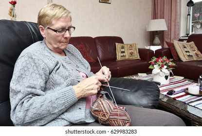 An Elderly Woman Is Knitting Some Socks