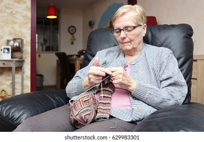 An Elderly Woman Is Knitting Some Socks