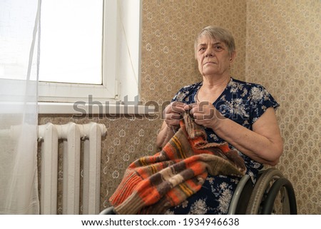 Similar – Senior woman in a wheelchair alone