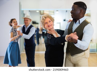 Elderly Woman Learning Ballroom Dancing In Pair