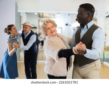 Elderly woman learning ballroom dancing in pair - Powered by Shutterstock