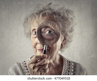 Elderly Woman Looking Through A Magnifying Glass