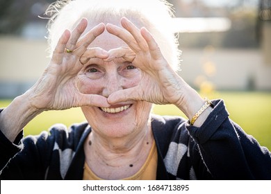 Elderly Woman Making Heart Shape With Hands