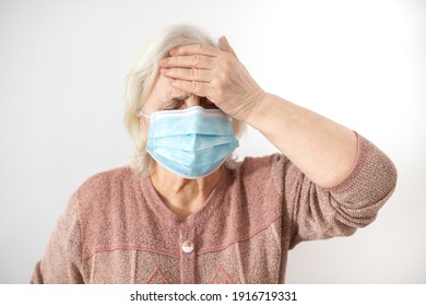 Elderly Woman With Mask Having Headache Beacause Of Covid Illness