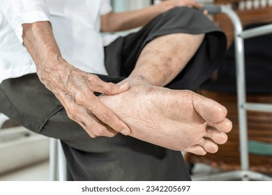 Elderly woman massage her foot,Plantar fasciitis,pain in soles of foot and heel bone,Tarsal tunnel syndrome,compression of a nerve in foot or Achilles tendonitis,inflammation of tendon at back of heel