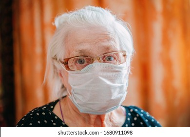 An Elderly Woman In A Medical Mask.