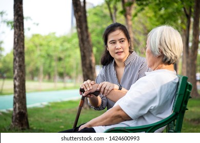 Elderly Woman Or Mother With Depressive Symptoms, Alzheimer Patient,asian Female Caregiver Or Daughter Holding Elderly Patient’s Hand Comforting,support In Outdoor Park Feeling Sad,depression Concept