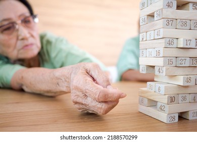 Elderly Woman Playing Games On Table With Elderly Friends Having Activities In Nursing Home, Seniors With Happy Life Concept