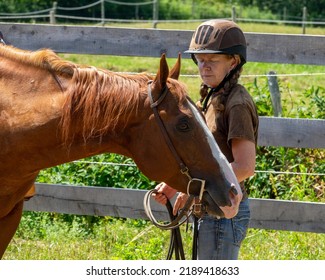 An Elderly Woman Playing With Her Horse