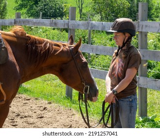 An Elderly Woman Playing With Her Horse