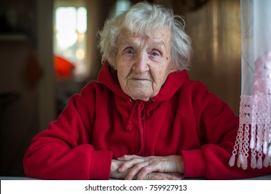 Elderly Woman Portrait In A Bright Red Jacket.