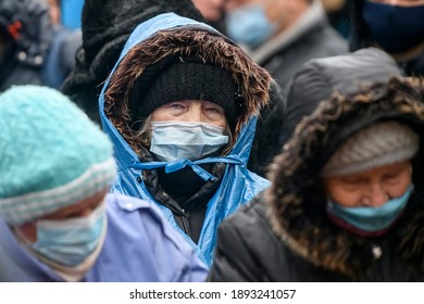 Elderly Woman In A Protective Mask Against Coronavirus Covid 19 On The Street In Kyiv, Ukraine. January 2021