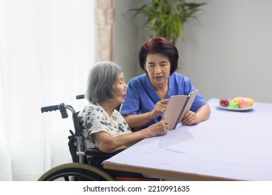 Elderly woman reading aloud a book for dementia therapy with caregiver. - Powered by Shutterstock