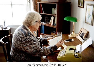 Elderly woman reading at a desk with a typewriter. Cozy room with books and a lamp. Elderly woman focused on reading. Peaceful atmosphere with a typewriter. Senior woman writing a letter. - Powered by Shutterstock