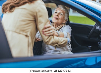 An elderly woman receives assistance from a caregiver while getting out of a car, symbolizing support, care, and kindness in daily life. - Powered by Shutterstock