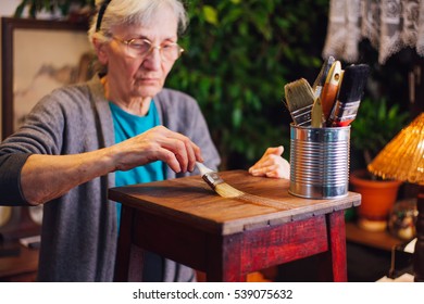 Elderly Woman Refurbishing Furniture