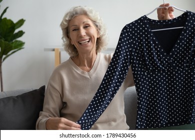 Elderly Woman Sit On Couch Show Blouse Look At Camera, Aged Lady Blogger Share Brand New Wear, Fashion Store For Old Women, E-commerce Buy Sell Through E-store, Distance Purchase, Modern Tech Concept