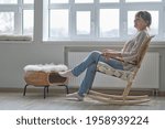 elderly woman sits in a wicker rocking chair. woman resting in armchair. Joy of life