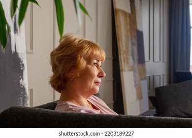 Elderly Woman Sitting On Couch. Profile Portrait.