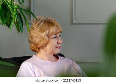 Elderly Woman Sitting On Couch. Profile Portrait.