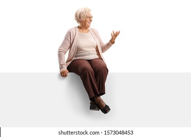 Elderly woman sitting on a panel looking to the side and gesturing with hand isolated on white background